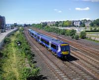 A service from Edinburgh approaches journey's end while in the distance an opposite number climbs for the bridge. Behind is Buckingham Junction where the link to Dundee (Tay Bridge) station left Perth line on the approach to the Dundee West terminus.<br><br>[David Panton 31/05/2016]