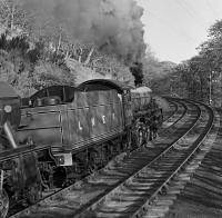 Preserved B1 No. 61306 (it was never an LNER loco) leads ‘Flying Scotsman' round the sharp curve between Park South and Dalton Junctions, avoiding Barrow in Furness with the M&GNJRS 'The Lakelander’ special returning from Sellafield to London Euston on 8 May 1976. The B1 gave way to ex-LNWR Precedent class No. 790 ‘Hardwicke’ at Ulverston and steam was replaced by electric power at Carnforth. I have somehow managed to gain some elevation, possibly standing on a lineside cabinet, and no-one batted an eyelid - how times change!<br><br>[Bill Jamieson 08/05/1976]