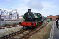 0-4-0ST Agecroft No.1 takes visitors to the Manchester Museum of Science and Industry on a short ride in two replica L&M coaches. On the right is an English Electric 4w battery loco, works number 1378 of 1944.<br><br>[John McIntyre 04/06/2016]