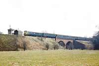 A southbound DMU for Largs passes Dalgarven signal box and crosses the River Garnock.<br><br>[Colin Miller /06/1969]