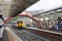 156448 arrives at a clean and bright Hexham station with a stopping service from Newcastle that will terminate here. Departure for the return trip from Platform 1 is controlled by the starting signal to the right of the unit, which will run <I>wrong line</I> to the crossover beyond the signal box.<br><br>[Mark Bartlett 02/05/2016]