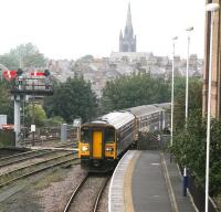 The 13.05 Knaresborough - Leeds DMU service runs into Harrogate on a grey and overcast 27 September 2010. The train is formed by single unit 153359 with 2-car unit 155341 attached. The spire of the former St Luke's church stands on the horizon.<br><br>[John Furnevel 27/09/2010]