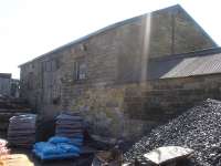 The old railway goods shed alongside Helmsley station is still in daily use by the local coal and wood merchant, as seen in this May 2016 view looking south, with the station and signal box behind the camera.<br><br>[David Pesterfield 09/05/2016]