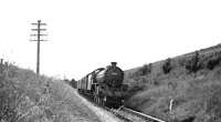 An unidentified B1 4-6-0 with an Edinburgh - Galashiels train eastbound on the Peebles loop in the 1950s. The location is thought to be the section between Angling Club Cottage and Clovenfords [see image 31488]. [Ref query 10023]<br><br>[Dougie Squance (Courtesy Bruce McCartney) //]