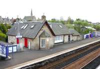 Looking over the 1869 station at West Calder from the A71 road bridge in May 2005, with the main building now in use as a restaurant. In the background is the United Free Church of Scotland on Limefield Road and, to the right, part of the old goods shed can just be seen [see image 15545].<br><br>[John Furnevel 01/05/2005]