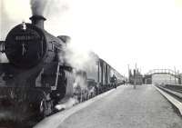 A train about to leave Maud for Aberdeen on 19 April 1954 behind BR Standard class 4 80028.<br><br>[G H Robin collection by courtesy of the Mitchell Library, Glasgow 19/04/1954]