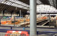Queen Street High level on 4th July 2016 seen over the partition which separates the building site from the passengers. OHLE headspan masts now rise above the temporary metal safety fencing on the platforms.<br><br>[Colin McDonald 04/07/2016]