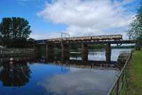 A mixed livery train crossing the River Leven viewed from the Dumbarton bank.<br><br>[Ewan Crawford 20/06/2016]