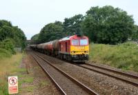 The Robeston to Westerleigh Murco oil tanks approach Pyle station with 60044.<br><br>[Alastair McLellan 06/07/2016]