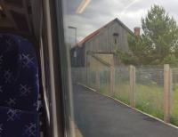 The surviving Highland Railway goods shed at Brora seen from a northbound train.<br><br>[John Yellowlees 30/06/2016]