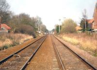 View east towards Malton and Scarborough from York Road level crossing in Strensall on 3 April 2016. Princess Road level crossing can be seen in the middle distance, whilst beyond, by the former station site, is Lords Moor Lane level crossing and manual signal box.<br><br>[David Pesterfield 03/04/2016]