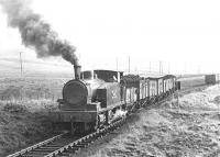 A trainload of coal from Pennyvenie pauses at the west end of the loop between Minnivey and Dunaskin Washery in March 1972. The locomotive is NCB West Ayr Area No 24 (AB 2335/1953), fitted with Giesl ejector. On the right is a train of empties making the return journey from the washery. The various angles of the waggons suggest this section was anything but a smooth ride.<br><br><br>[John Furnevel 04/03/1972]