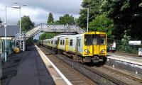 A six-car service from Ormskirk  to Liverpool Central calls at Maghull (pronounced MaggULL) station on 29/06/2016.<br><br>[David Panton 29/06/2016]