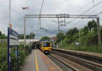 The nicely numbered 323232 pauses at Heald Green on the Styal Loop with a Crewe to Manchester Piccadilly (via the Airport) stopping service. Overhead an Easyjet Airbus has wheels down on final approach to Manchester.<br><br>[Mark Bartlett 17/06/2016]