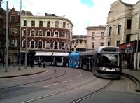 You have to have some patience to photograph so few pedestrians! A Southbound tram approaches the Lace Market stop in central Nottingham. Notice the diamond-shaped speed limit sign for trams on the left.<br><br>[Ken Strachan 23/04/2016]