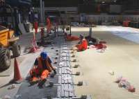 Work to refit barriers taking place on 21st July 2016. The resurfaced concourse to the right hides the extensive preparations for extending platforms 2,3,4 & 5 southwards towards George Square which took place during the closure of the High Level station [see image 55687].<br><br>[Colin McDonald 21/07/2016]