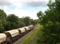 GBRf 66749 heads south along the former four track Midland Main line, shortly after passing the former Sandal & Walton station site, with a cargo of silica sand from Middleton Towers in Norfolk destined for the glassworks at Monk Bretton near Barnsley. The section of track forward of the loco originally ran through a tunnel, but was opened up when the line was increased from two tracks to four.  <br><br>[David Pesterfield 13/07/2016]