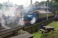 A steamy departure from Haverthwaite on 10 July 2016 as a Barclay 0-6-0T heads for Lakeside with a well loaded train.<br><br>[John McIntyre 10/07/2016]