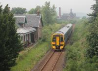 158721 passes the closed station at Edderton, and the Balblair Distillery, heading for Thurso and Wick with a service from Inverness on a misty 20th July 2016.<br><br>[Mark Bartlett 20/07/2016]