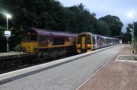 Late evening scene at Tain with DB 66100 and 158704. The 66 was on a long train of empty bogie wagons from Georgemas Junction and running 90 minutes late at this point. It would have a further wait here for the 158 on the 2216hrs Tain to Inverness service to clear the section to Invergordon.<br><br>[Mark Bartlett 21/07/2016]