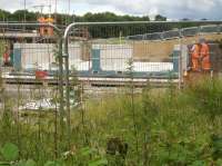 The completed bridge deck for the replacement bridge across Haigh Lane is having holes drilled into the sides, prior to assembly onto the abutments as a further stage to creating a complete bridge unit ready to be moved to position and lowered onto solid concrete footings alongside the remaining lower section of the existing stone abutments. <br><br>[David Pesterfield 13/07/2016]