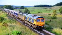 The southbound Inverness portion of the Caledonian Sleeper climbing<br>
the gradient past the small hamlet of Castletown near Daviot. Leading<br>
is sparkling 66733 Cambridge PSB followed by a grubby 73697. In the<br>
last year or so the sleeper has been hauled by, first,a class 67, then<br>
two class 67s, then a 67 and a 73, sometimes two 73s and now the<br>
combination as pictured.<br><br>[John Gray 12/07/2016]