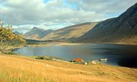 With the opening of the Callander and Oban through to Oban in 1880, various new routes opened. A circular route from Oban to Achnacloich (train) to Lochetivehead (ferry) to Kingshouse (coach) to Ballachulish (coach) to Oban (ferry or train from 1903) became available to tourists. Variations of this existed prior to that date and the ferry from Achnacloich to Lochetivehead has continued intermittently since under various different operators.<br><br>
<br><br>
The photograph is taken from close to a charcoal burning platform originally associated with the Glen Kinglass Iron Works and the view shows the disused pier looking north east. Inveretive and Glen Etive are in the background.<br><br>[Ewan Crawford //1995]