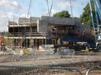 The bridge deck for the replacement Haigh Lane overbridge is seen being steadily lowered over securing bolts that will tie it to, and take all the weight of, the abutments during the short journey being transported to its final position astride a heavy lift vehicle. <br><br>[David Pesterfield 14/07/2016]