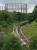 View over Kelvindale Station with a Glasgow Queen Street - Dundee<br>
approaching.  The gasholder frames of Dawsholm Gasworks dominate the<br>
skyline.<br><br>[Bill Roberton 18/07/2016]