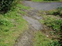 A short section of points assembly is still in position immediately adjacent to the rear boundary fence to a site on the Claycliffe Industrial Estate at Barugh on the west side of Barnsley, as come across during an off the beaten track walk whilst our extensively used 2003 MG saloon, with 300,000 Km on the clock, was gaining an MOT pass. The line ran on a short embankment from Silkstone Junction on the Barnsley to Horbury Junction section of line, approx 100m away to left of view, to serve a chemical works that previously stood on the site of what is now a steel reinforcing mesh manufacturing site, whilst a line turned west to run via Barnby Bridge Junction to access Stanhope and Higham Collieries. [See image 56220]<br><br>[David Pesterfield 21/07/2016]