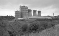 After limestone trains were delivered to the works by British Rail, they were drawn to this reversing spur in the south east of the works before heading to the unloading point. Below the gasometers are seen the machine shop and locomotive shed. On the right is the south end of the unloading area for coal trains, the wagon being on a cable. A wisp of steam in the background right implies that, despite closure, some part of the power station was still in operation. Sadly the locomotives had been dispersed and none were sitting at their usual stabling point.<br><br>[Bill Roberton //1992]