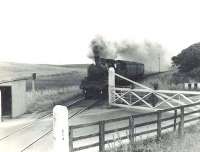 BR Standard class 2 2-6-0 78045, approaching with a train from the Banff direction, is about to pass over Inverboyndie level crossing on 23 August 1963. [Ref query 15240] <br><br>[G H Robin collection by courtesy of the Mitchell Library, Glasgow 23/08/1963]