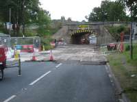 Friday evening before the line blockage starts at 23.30, all is in place ready for the demolition of the upper section of the stone arch bridge over Haigh Lane, and the rolling in of the replacement concrete bridge constructed off view to left [See image 56037]. A 52 hour line possession is in place for the replacement works to be completed.<br><br>[David Pesterfield 05/08/2016]