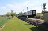 A photograph with history from a trip to Belgium.<br>
<br>
A Gent to Poperinge train passes Larchwood Railway Cuttings Cemetery on the outskirts of Ypres. 100 years earlier the scene was very much different in that the trees above the cemetery is Hill 60 where some of the heaviest fighting of the WW1 took place.<br><br>[Alastair McLellan 13/05/2015]