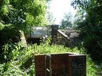 A sylvan setting appears to be the case for this occupation overbridge running below the Barnsley to Horbury Junction section of line to the rear of the Claycliffe Industrial Estate at Barugh to west side of Barnsley. The bridge, BAH2-30, is located some 250m south of Dearne Hall Road over-bridge with Silkstone Junction some 50m north, to left, of view, and is within a former industrial & mining location. The view belies the true surroundings.  <br><br>[David Pesterfield 21/07/2016]