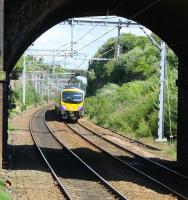 185121, on a TPE Newcastle to Liverpool service, is nearing journey's end as it passes through the famous Olive Mount cutting and approaches the platforms of Wavertree Technology Park station. [See image 11892] for an earlier view of this location, since when the junction with the line to the docks has been reinstated and the Liverpool and Manchester line has been electrified. <br><br>[Mark Bartlett 13/07/2016]