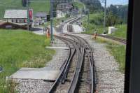 <I>Mountain junction</I>. Just below the summit station of Rigi Kulm is Rigi Staffel station where the two lines, to Vitznau (right) and Arth Goldau diverge. They are operated as separate lines but there is a connection here between the two systems. A day ticket is valid on both lines and associated cable cars. This view taken from a descending car heading for Arth Goldau. <br><br>[Mark Bartlett 27/06/2016]