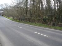 A lower section of a bridge abutment stands on the south side of the A635 between Barnsley and Cawthorne. It was on the Silkstone Branch of the Lancashire & Yorkshire Railway that formerly ran from Silkstone Junction on the Barnsley to Horbury Junction line, near Barugh. The line ran ahead towards Stanhope Colliery, with a line turning off east, just south of the bridge, to access Higham Colliery. The M1 motorway bridge can be seen to upper left of view, with the parapet of the Silkstone Beck seen on centre right of view. [See image 56088]<br><br>[David Pesterfield 31/03/2016]