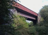 A couple of miles South East of Brackley [see image 52362], this determined-looking girder bridge carried the Great Central over the LNWR line from Verney Junction to Banbury. The bridge is very rusty, so if HS2 comes this way, they will need to replace it. View looks along the bridlepath to Fulwell and Westbury station site.<br>
<br>
Current plans for the HS2 route take the line on a new alignment slightly further east.<br><br>[Ken Strachan 13/08/2016]