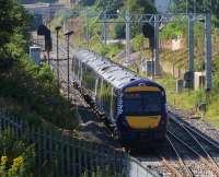 A guard gazes at the gantries which now grace the Cowlairs Incline as a Class 170 DMU from Aberdeen decends towards Queen Street.<br><br>[Colin McDonald 17/08/2016]