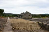 Having been hidden by trees for around forty years,the former station at Grantown-on-Spey (East) is now out in the open after a major site clearance. The plan,by Revack Lodge Estate, is to turn the building into a heritage centre and shop, with two railway coaches, placed on rails between the platforms, as a cafe. The infill between the platforms will be part of a new access road from the A95.<br><br>[John Gray 23/08/2016]