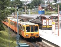 A South Hylton - Newcastle Airport Metro service arrives at Pelaw in the summer of 2004. The former station master's house stands in the right background.<br><br>[John Furnevel 10/07/2004]