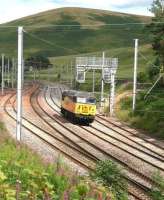 A lonely looking Colas Rail 56087 runs south through the loops at Abington on 27 July 2016.<br><br>[John Furnevel 27/07/2016]