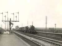 A down freight trundles through Hurlford in the spring of 1954 behind Stanier 8F 2-8-0 48612. <br><br>[G H Robin collection by courtesy of the Mitchell Library, Glasgow 06/05/1954]