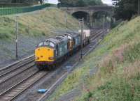 <I>What a difference a summer makes</I>. The recently upgraded cutting at Hampson Lane near Galgate is already looking less than pristine. 37059 and 37605 pass through heading for Sellafield on 26th August 2016. [See image 54677] for the same location just four months earlier. <br><br>[Mark Bartlett 26/08/2016]
