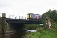 My attempt to recreate the Mark Bartlett photo [see image 53470] has been thwarted by the vegetation. Here a Preston to Ormskirk shuttle crosses the Leeds Liverpool Canal (Rufford Branch) just south of Rufford station. The bridge also forms an occupation crossing known as Canal Bridge Crossing. While this was a Sunday and there isn't normally any train service on a Sunday, 28 August 2016 was an exception with a special timetable being used in connection with the Ormskirk Motorfest.<br><br>[John McIntyre 28/08/2016]