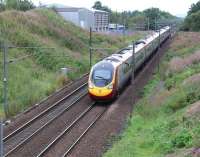 The 1051 Edinburgh Waverley - London Euston via Birmingham New Street approaching Carstairs East Junction on 31 August 2016. The train is passing a large works depot occupied by South Lanarkshire Council roads department. The depot stands on the site once occupied by Carnwath station (closed 1966).<br><br>[John Furnevel 31/08/2016]