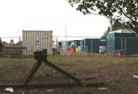 View from the eastern perimeter of Millerhill Yard on 7 September 2016 with modular accommodation and storage in place and fencing erected. This is the north eastern corner of the old yard, with the buffer stops marking the limit of the former ballast siding [see image 3447]. Whitehill Road runs just beyond the structures on the right. (COSHH = Control of substances hazardous to health.) The EGIP electric train depot is scheduled to open at Millerhill during 2017.<br><br>[John Furnevel 07/09/2016]