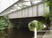 There is an old saying... <I>'two's company, three's a crowd'.</I> This could apply to the railway bridges over the initial section of the Dewsbury branch of the Calder & Hebble Navigation Canal at Thornhill Lees, where the two rail bridges, the original stone arch bridge and a later steel bridge, have kept close company with each other for many decades; only to have a new bridge carrying an high pressure gas pipeline placed up close and impersonal on the south side. The gas pipeline runs east to west along the solum of the redundant section of former four track trackbed and then turns north to run along the trackbed of the former Spen Valley line towards Cleckheaton.      <br><br>[David Pesterfield 22/07/2016]