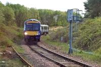This rural branch line scene is misleading, for it is actually the north curve of the Cowlairs triangular junction in Glasgow. During the temporary closure of Glasgow Queen Street High Level in 2016, this curve was brought into use for services between Queen Street Low Level and Stirling/Alloa/Dunblane. The train is the 16.52 Low Level to Alloa service on 16th May that year. It is awaiting passage of the 17.01 Low Level to Edinburgh (via Springburn) service in order to proceed on to the main line.<br><br>[Mark Dufton 16/05/2016]